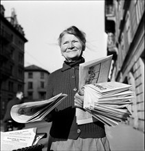 Newspaper home delivery by Mrs. Straub, on duty for 50 years; Zurich ca,. 1950.