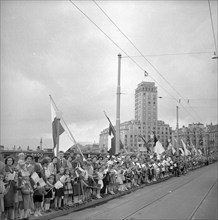 50th anniversary of the Simplon railway tunnel, onlookers waiting roadside in Lausanne 1956.