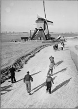 People ice skating in Holland, 1956.