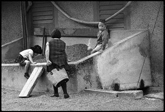 Children playing in a sandpit, 1968.