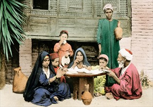 This 1903 illustration shows an arab family at dinner.