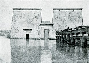 This photo shows the south front of temple of Isis at Philae during the inundation period, the time