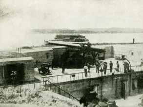 This photo, dating to before 1922, relates to World War I. The caption reads: THESE GIANT GUNS