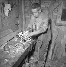 Alpthal; carpenter in his workshop; 1951.