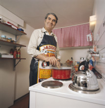 Pierre Arnold 1976 in his kitchen, cooking.