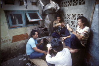 Men playing cards in Jakarta, Indonesia, 1986.