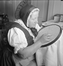 Woman embroidering, 1941.