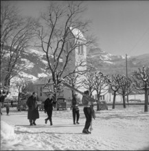 Lenk; passerby carrying skis; 1957.