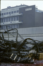 Fire Schweizerhalle 1986: destroyed warehouse in front of Sandoz-logo.