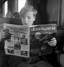 Reading a magazine in the train.