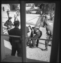 War fire brigade positioning a ladder, 1939.