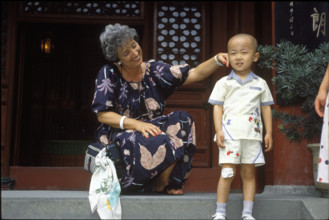 Catherine Delamuraz with Chinese child, China 1992.