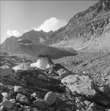 Bizarrely formed stone at Aletsch Glacier, circa in 1950.