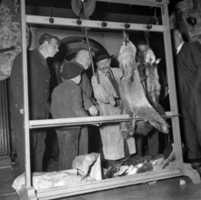Zurich; hunters offering pelts for sale; 1964.