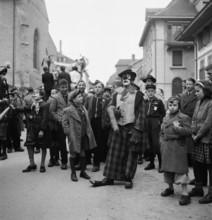 Clown and children at carnival parade in Payerne, 1946.