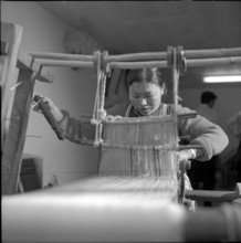 Tbetan woman at manual loom, Waldstatt 1963.