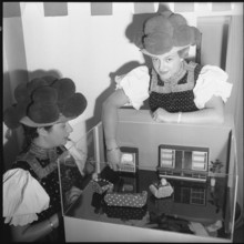 Radio and television fair: doll's house with television set, 1957.