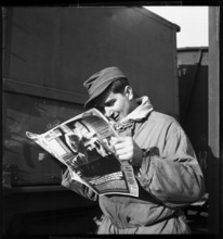 Transit;  prisoner of war reading Swiss Magazine; 1945.