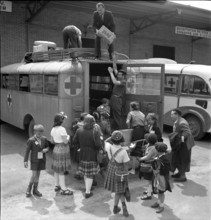 Journey home with a bus of the Swiss Red Cross; loading of the bus.