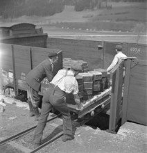Workers loading casted asphalt in goods train; 1941.