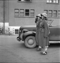 Members of women's military service; drivers salute.