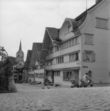 Girl on tricycle in Herisau; 1945.