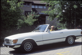 Walter Andreas Muller in his Mercedes convertible 1990.