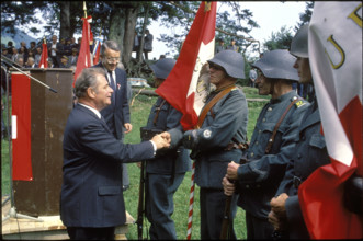 Jean Pascal Delamuraz greets flag guard.