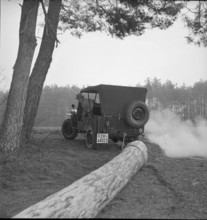 Military Jeep towing spruce trunk 1950.