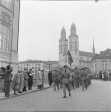 Military officers marching across Munsterbrucke, Zurich 1957.