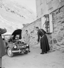 Great St. Bernhard: monk serving at gasoline pump; 1953.