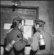 Valais, Grone coal mine, workers reading announcement at the noticeboard; 1957.