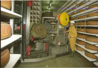 Employee with robot in cheese storage depot 1995.
