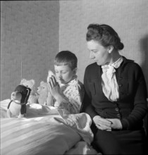 Mother and son praying, 1941.