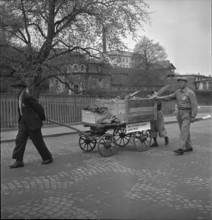Men gathering non-ferrous metal, handcart; 1942.