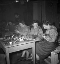 Women's reserve unit, women repairing electrical appliances; 1942.