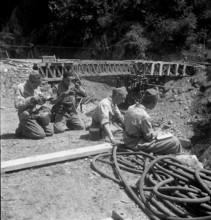 After high water: pioneer troop building temporary bridge, Riazzino 1948.