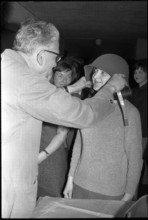 Woman soldier getting helmet, armoury Kreuzlingen 1964.