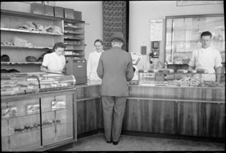 Customer in baker's shop; around 1940.