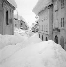 Airolo 1951, snow covered deserted lane.