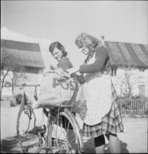 WW2 : farming camp; girl, young woman, mail, postal bag on bicycle, 1943.