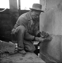 Stonemason working on facade, Lausanne 1957.