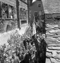 Procession with brass band on Corpus Christi in the Valais village Ayent, 1943.