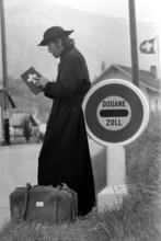 Jesuit leaning on customs sign, 1973