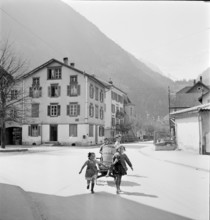 Girls carrying wooden handcart in Erstfeld; 1942