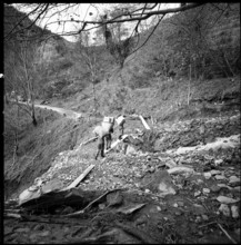 Landslide in the Misox valley, men carrying goods to supply the population; 1960