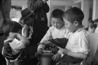 Tibetan boys playing with ashtray at Zurich airport 1963