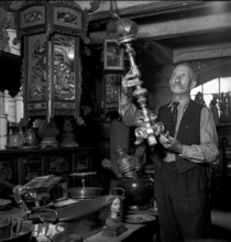 Geneva: antique dealer in his shop; 1943