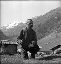 Farmer praying in the Turtmanntal valley, Switzerland, 1940