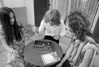 Young adults playing a board game, 1972